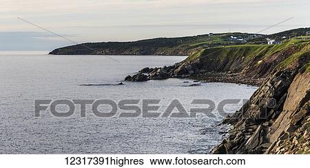 Stock Photograph - Rugged cliffs along the Atlantic coastline, Cape Breton Island; Belle Cote, Nova Scotia, Canada. Fotosearch