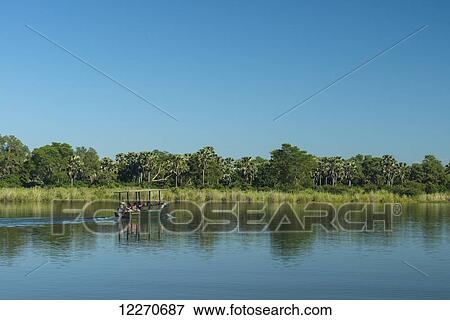 Stock Photo - Safari boat going up the Shire River, Liwonde National Park; Malawi. Fotosearch