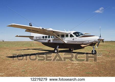 Stock Photo - Safarilink Cessna 208 Caravan on the airstrip, Mara Naboisho Conservancy; Kenya. Fotosearch