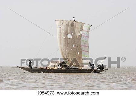 Stock Image - Sail boat on Lake Debo, formed by the seasonal flooding of the Niger River, Mali. Fotosearch