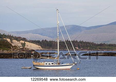 Sailboat moored in a lake, near Sneem; County Kerry, Ireland View Large Photo Image Stock Photo - Sailboat moored in a lake, near Sneem; County Kerry, Ireland. Fotosearch