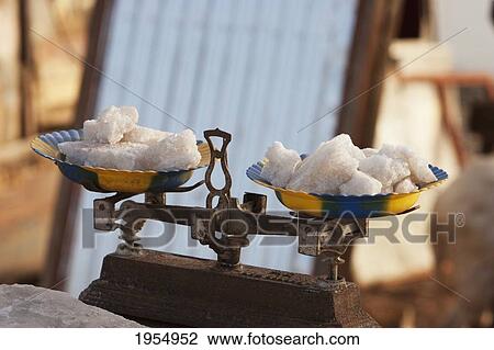 Stock Image - Salt from the Sahara on weighing scale for sale in Mopti, Mali. Fotosearch