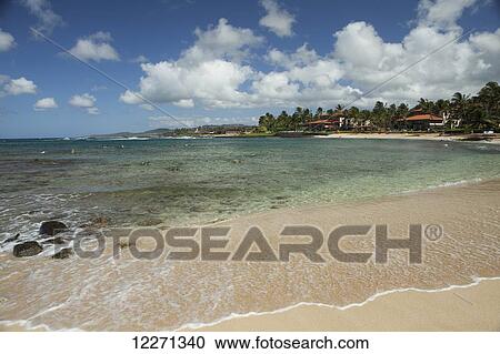 Stock Image - Sand and reef, Poipu Beach Park; Kauai, Hawaii, United States of America. Fotosearch