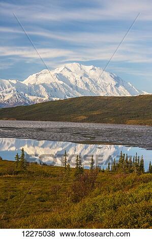 Stock Photo - Scenic autumn view of Mt. McKinley and Wonder Lake partially covered with ice, Denali National Park, Interior Alaska. Fotosearch