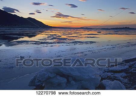 Stock Photo - Scenic sunset view of Knik Arm with ice chunks near the Glenn Highway, Southcentral Alaska, Winter. Fotosearch