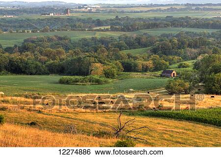 Stock Photograph - Scenic view of farmland and the Mississippi River Valley at sunrise, near Balltown; Iowa, United States of America. Fotosearch