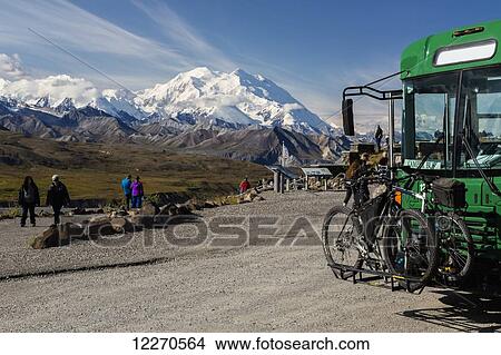 Picture - Scenic view of Mt. McKinley from Eielson Visitor Center with a park camper bus with bicycles in the foreground in Denali National Park, Interior Alaska, Summer, USA.. Fotosearch