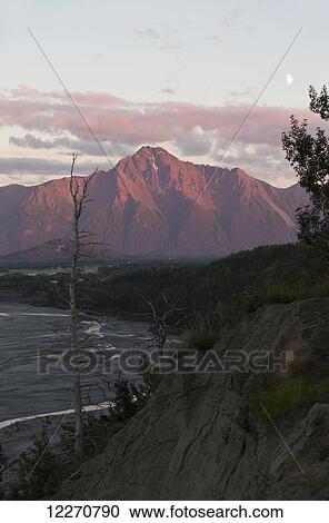 Stock Image - Scenic view of Pioneer Peak and the Matanuska River at sunset, Mat-Su Valley, Southcentral Alaska, Autumn. Fotosearch