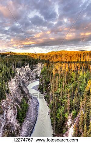 Scenic view of the Kuskulana River Canyon and Wrangell Mountains at sunset from the Kuskulana River Bridge on the McCarthy Road in Wrangell-St. Elias National Park and Preserve, Southcentral Alaska, Spring, HDR View Large Photo Image Stock Photo - Scenic view of the Kuskulana River Canyon and Wrangell Mountains at sunset from the Kuskulana River Bridge on the McCarthy Road in Wrangell-St. Elias National Park and Preserve, Southcentral Alaska, Spring, HDR. Fotosearch