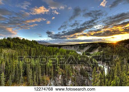 Scenic view of the Kuskulana River Canyon at sunset from the Kuskulana River Bridge on the McCarthy Road in Wrangell-St. Elias National Park and Preserve, Southcentral Alaska, Spring, HDR View Large Photo Image Stock Photo - Scenic view of the Kuskulana River Canyon at sunset from the Kuskulana River Bridge on the McCarthy Road in Wrangell-St. Elias National Park and Preserve, Southcentral Alaska, Spring, HDR. Fotosearch