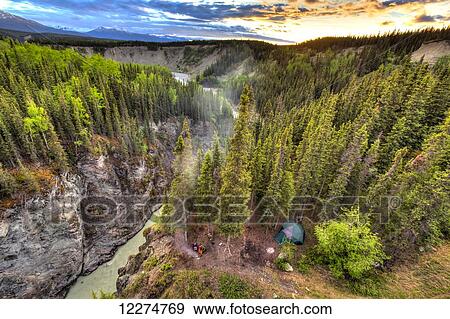 Scenic view of the Kuskulana River Canyon and Wrangell Mountains at sunset from the Kuskulana River Bridge on the McCarthy Road in Wrangell-St. Elias National Park and Preserve, Southcentral Alaska, Spring, HDR View Large Photo Image Stock Photo - Scenic view of the Kuskulana River Canyon and Wrangell Mountains at sunset from the Kuskulana River Bridge on the McCarthy Road in Wrangell-St. Elias National Park and Preserve, Southcentral Alaska, Spring, HDR. Fotosearch