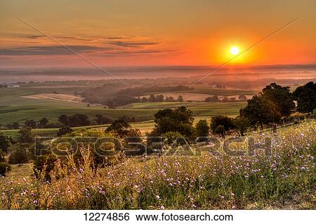 Stock Photograph - Scenic view of the Mississippi River Valley and flowers along the Great River Road at sunrise, near Balltown; Iowa, United States of America. Fotosearch