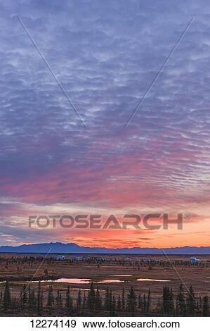 Stock Photo - Scenic view of the village of Noatak with the Baird Mountains in the distance at sunrise, Arctic Alaska, USA, Autumn. Fotosearch