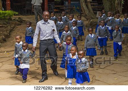Stock Image - Schoolchildren at the Giraffe Centre; Nairobi, Kenya. Fotosearch