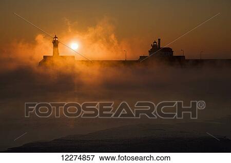Sea smoke over Lake Superior and the Canal Park Lighthouse at sunrise; Duluth, Minnesota, United States of America View Large Photo Image Stock Photo - Sea smoke over Lake Superior and the Canal Park Lighthouse at sunrise; Duluth, Minnesota, United States of America. Fotosearch