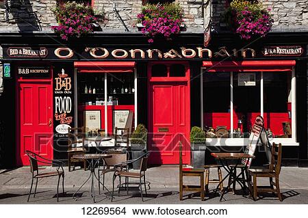 Seating outside a pub with red doors View Large Photo Image Picture - Seating outside a pub with red doors. Fotosearch