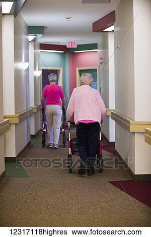 Senior Citizens Walking Down Shared Residence Hallway; Devon, Alberta, Canada View Large Photo Image Stock Photograph - Senior Citizens Walking Down Shared Residence Hallway; Devon, Alberta, Canada. Fotosearch