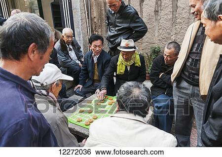 Senior men playing Chinese chess on the street every afternoon; Xiamen, Fujian Province, China View Large Photo Image Stock Photograph - Senior men playing Chinese chess on the street every afternoon; Xiamen, Fujian Province, China. Fotosearch