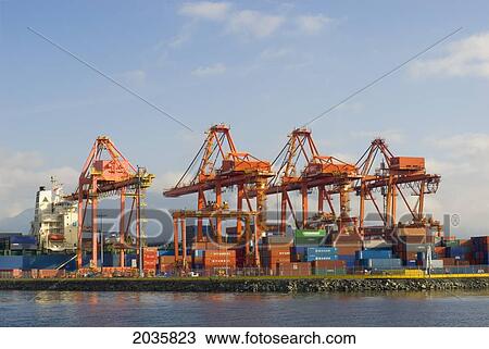 Stock Image - Ship Being Unloaded At Port Vancouver, Centrem Container Terminal, Vancouver, British Columbia. Fotosearch