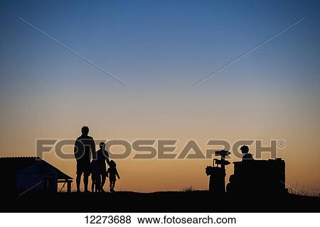 Silhouette of a family standing and watching the sunset; Cabo Polonio, Uruguay View Large Photo Image Stock Photo - Silhouette of a family standing and watching the sunset; Cabo Polonio, Uruguay. Fotosearch