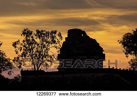 Silhouette of ancient Mayan Observatory with trees and colourful clouds at sunset; Chichen Itza, Yucatan, Mexico View Large Photo Image Stock Photo - Silhouette of ancient Mayan Observatory with trees and colourful clouds at sunset; Chichen Itza, Yucatan, Mexico. Fotosearch