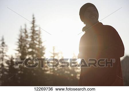 Stock Photograph - Silhouette of snowboarder, Haines, Southeast Alaska. Fotosearch