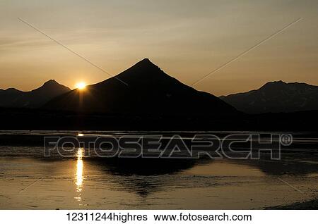 Silhouetted mountain peaks at sunset View Large Photo Image Stock Photograph - Silhouetted mountain peaks at sunset. Fotosearch