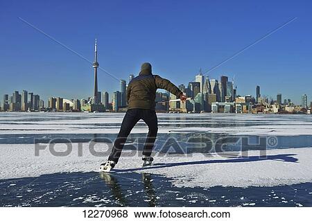 Skater and city skyline from Ward's Island; Toronto, Ontario, Canada View Large Photo Image Stock Photo - Skater and city skyline from Ward's Island; Toronto, Ontario, Canada. Fotosearch