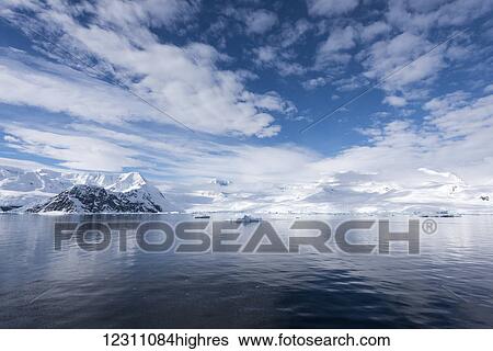 Stock Photograph - Sky reflected in water in Neko harbour; Antarctica. Fotosearch