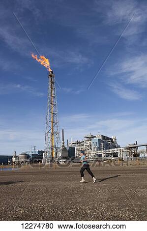 Slope worker running in the Endicott Fun Run with a flare tower and oil facilities in the background, Prudhoe Bay Oil field, North Slope, Arctic Alaska, Summer View Large Photo Image Stock Image - Slope worker running in the Endicott Fun Run with a flare tower and oil facilities in the background, Prudhoe Bay Oil field, North Slope, Arctic Alaska, Summer. Fotosearch