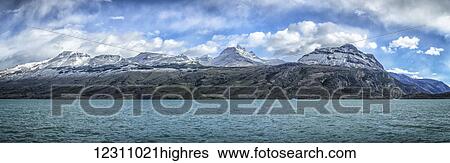 Stock Photograph - Snow capped mountains off North Branch of Lago Argentino in Patagonia; Santa Cruz Province, Argentina. Fotosearch