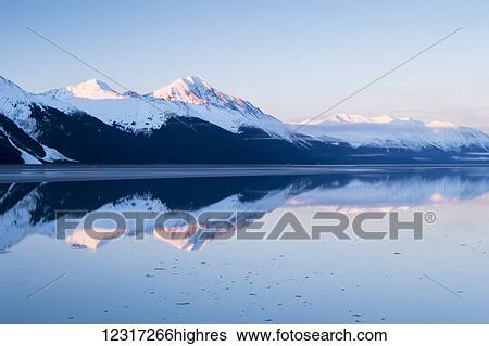 Snow covered mountains across Turnagain Arm in springtime, near Mile 87 of the Seward Highway; Alaska, United States of America View Large Photo Image Stock Photograph - Snow covered mountains across Turnagain Arm in springtime, near Mile 87 of the Seward Highway; Alaska, United States of America. Fotosearch
