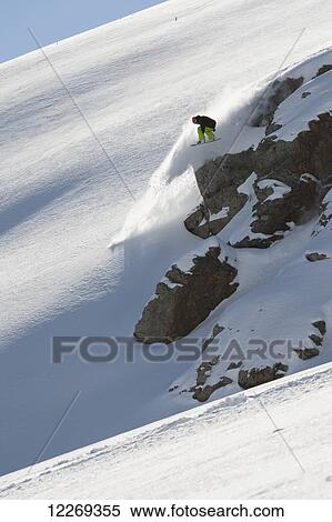 Stock Photography - Snowboarder on the extreme snowy slopes; Methven, New Zealand. Fotosearch