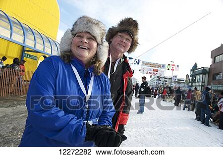 Stock Image - Spectators cheer on the dog teams and mushers at the start of the 2011 Iditarod Race in downtown Anchorage, Alaska. Fotosearch