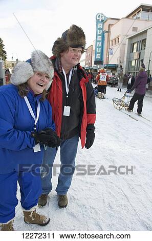 Stock Image - Spectators cheer on the dog teams and mushers at the start of the 2011 Iditarod Race in downtown Anchorage, Alaska. Fotosearch