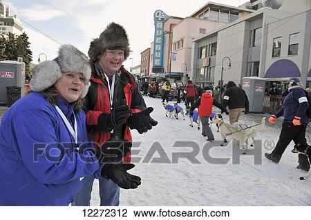 Spectators cheer on the dog teams and mushers at the start of the 2011 Iditarod Race in downtown Anchorage, Alaska View Large Photo Image Stock Image - Spectators cheer on the dog teams and mushers at the start of the 2011 Iditarod Race in downtown Anchorage, Alaska. Fotosearch