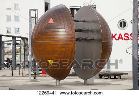 Stock Image - Spherical sculpture in the Market square; Gilching, Bayern, Germany. Fotosearch