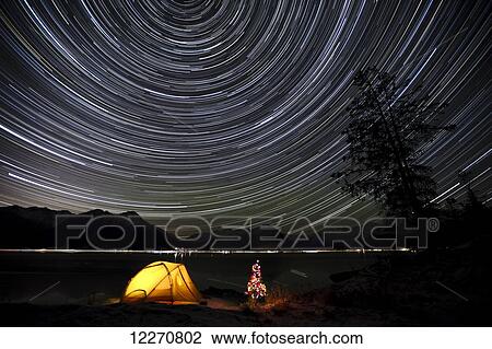 Star trails circle above the Chugach Mountains with a backpacking tent and Christmas Tree along the shore of Turnagain Arm, Southcentral, Alaska, Winter View Large Photo Image Stock Image - Star trails circle above the Chugach Mountains with a backpacking tent and Christmas Tree along the shore of Turnagain Arm, Southcentral, Alaska, Winter. Fotosearch