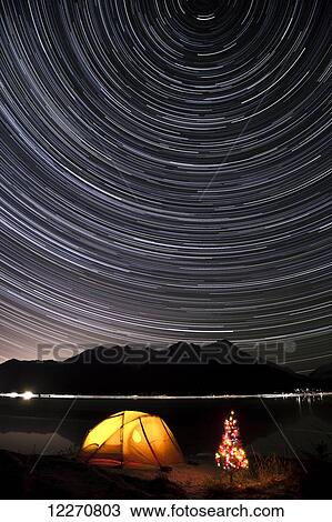 Star trails circle above the Chugach Mountains with a backpacking tent and Christmas Tree along the shore of Turnagain Arm, Southcentral, Alaska, Winter View Large Photo Image Stock Image - Star trails circle above the Chugach Mountains with a backpacking tent and Christmas Tree along the shore of Turnagain Arm, Southcentral, Alaska, Winter. Fotosearch
