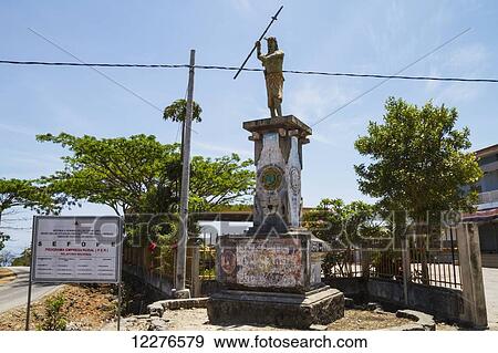 Stock Photo - Statue of a warrior with a weapon; Baucau, East Timor. Fotosearch