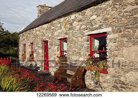 Stone cottage with red door and red trimmed windows; Sneem, County Kerry, Ireland View Large Photo Image Stock Photo - Stone cottage with red door and red trimmed windows; Sneem, County Kerry, Ireland. Fotosearch