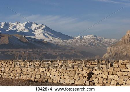 Stone Fence In Bamiyan With The Snow-Capped Hindu Kush Mountains In The Background, Bamian Province, Afghanistan View Large Photo Image Picture - Stone Fence In Bamiyan With The Snow-Capped Hindu Kush Mountains In The Background, Bamian Province, Afghanistan. Fotosearch