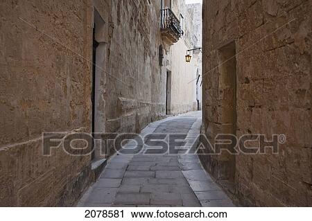 Stone Houses On A Narrow Street, Mdina, Malta View Large Photo Image Stock Image - Stone Houses On A Narrow Street, Mdina, Malta. Fotosearch