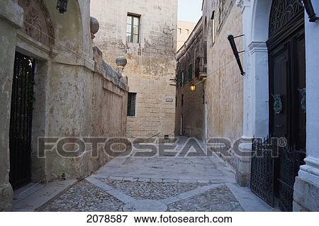 Stone Houses On A Narrow Street, Mdina, Malta View Large Photo Image Stock Photo - Stone Houses On A Narrow Street, Mdina, Malta. Fotosearch