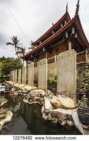 Stock Image - Stone turtles carrying stele by the Chihkan Tower (Fort Provintia); Tainan, Taiwan. Fotosearch