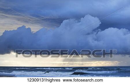 Stock Photograph - Stormy sunset over a west coast sea; Greymouth, South Island, New Zealand. Fotosearch
