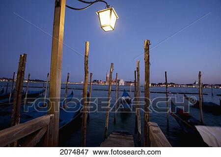 Street Lamp, Gondolas And Isola Di San Giorgio Maggiore At Dusk, Venice, Italy View Large Photo Image Stock Photo - Street Lamp, Gondolas And Isola Di San Giorgio Maggiore At Dusk, Venice, Italy. Fotosearch