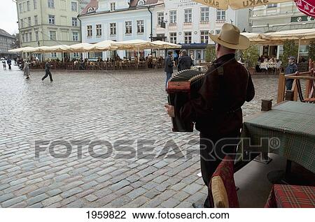 Stock Image - Street Musician Performing In Town Hall Square At Tallinn, Estonia. Fotosearch