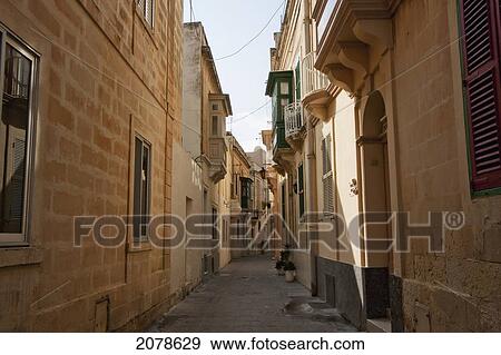 Street Scene Featuring Houses With Enclosed Balconies, Rabat, Malta View Large Photo Image Stock Photo - Street Scene Featuring Houses With Enclosed Balconies, Rabat, Malta. Fotosearch