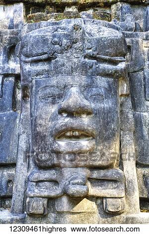 Stock Photograph - Stucco mask, The Mask Temple, Lamanai Mayan site; Belize. Fotosearch